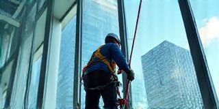 Cleaner washing high-rise windows